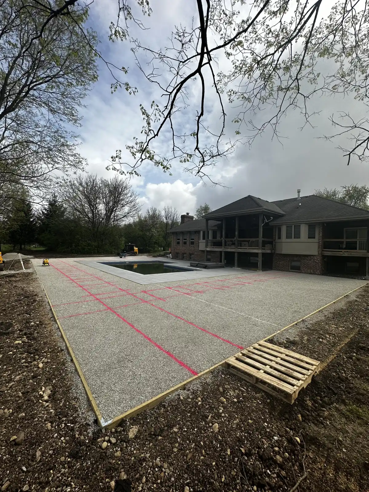 Excavation work for a residential turf installation showing drainage stone base