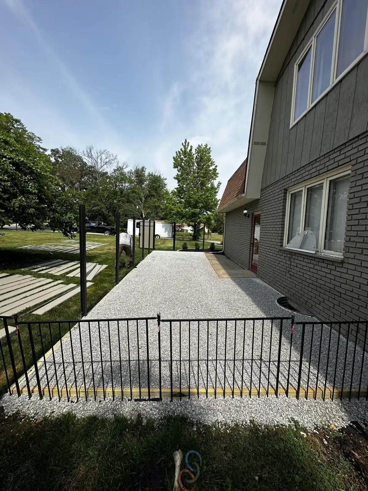 Aggregate base prepared for turf beside a home
