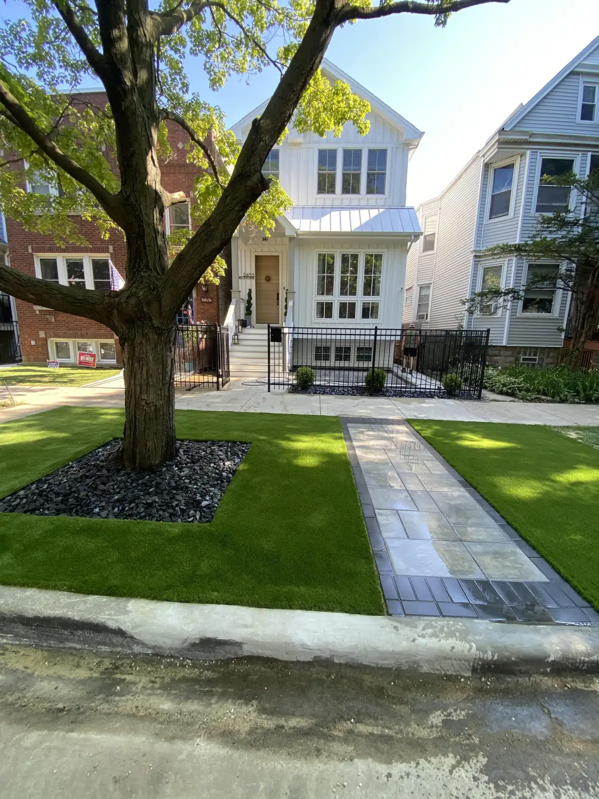 Finished front lawn with turf and a paver walkway