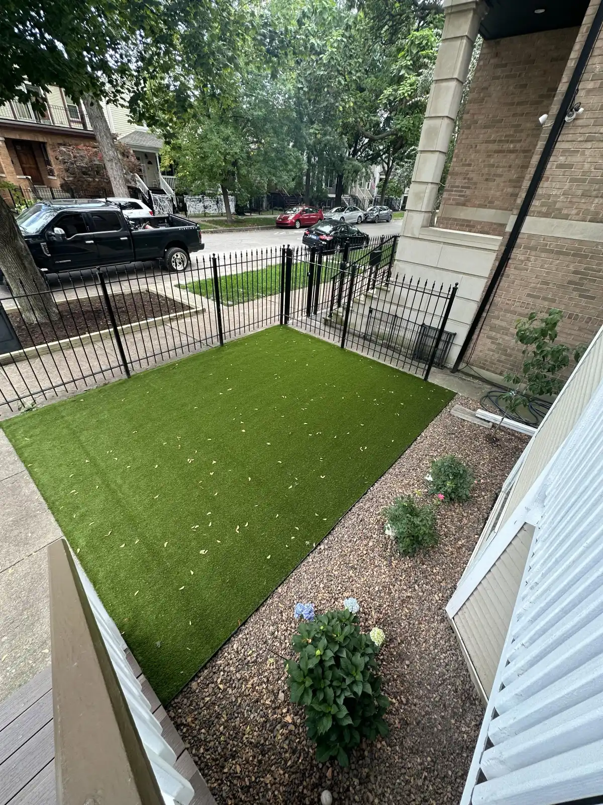Front yard synthetic turf with iron fence from elevated angle in Northern Michigan